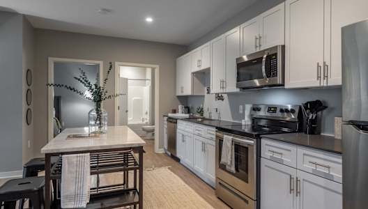 a kitchen with stainless steel appliances and a wooden table