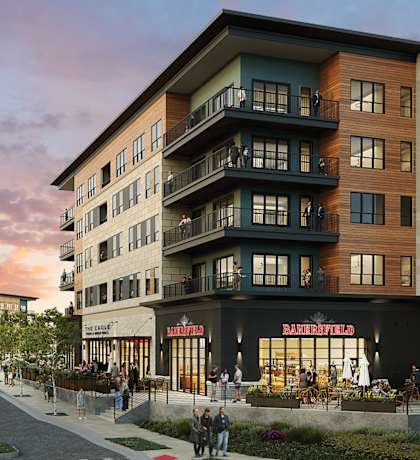 A street view of a building with the sign at The District at Deerfield Residences Apartments, Mason, OH, 45040