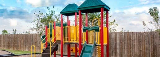 a playground with slides and swings in a park