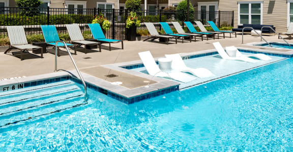 a swimming pool in front of an apartment building