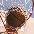 A basketball going through a hoop