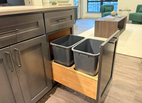 a kitchen with three storage bins in a counter top