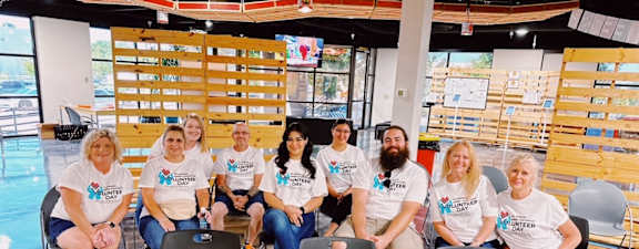 a group of people wearing t shirts posing for a picture