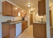 Thumbnail 9 of 20 - Fargo, ND Saddlebrook Apartments. A kitchen with white appliances