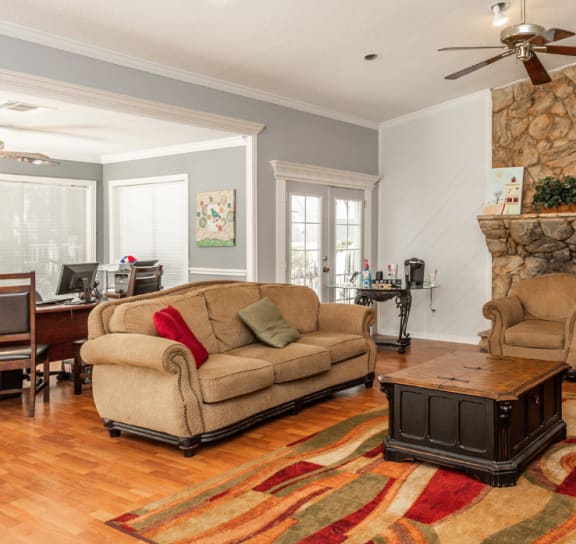 a living room with couches a coffee table and a fireplace