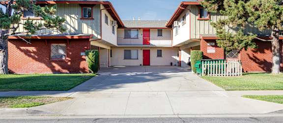a street view of an apartment building with a driveway