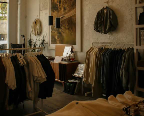 A clothing store with clothes hanging on racks.
