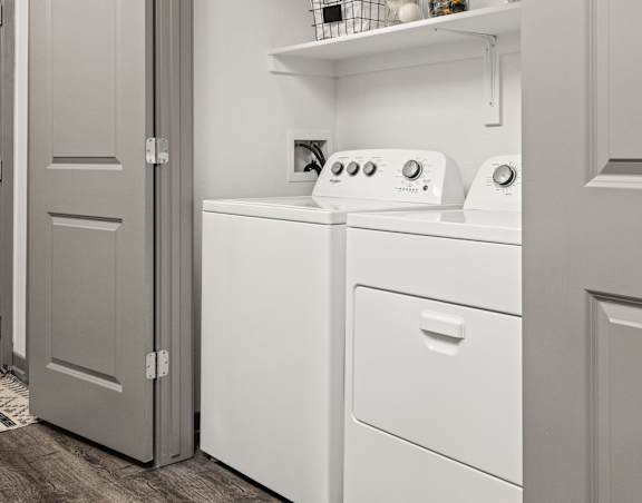 A small laundry room with a washer and dryer.