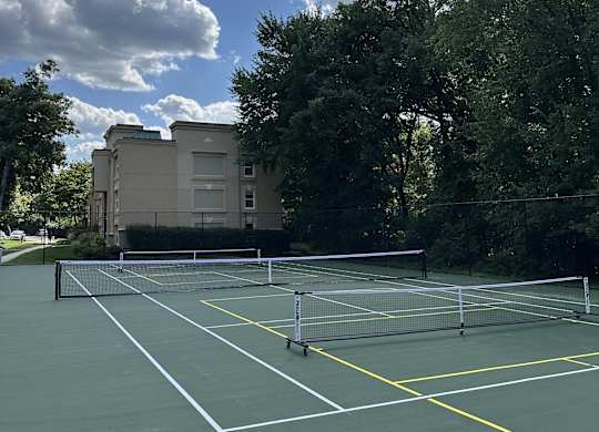 a view of a house from the roof of a tennis court at Stuart Woods* Apartments, Herndon, VA