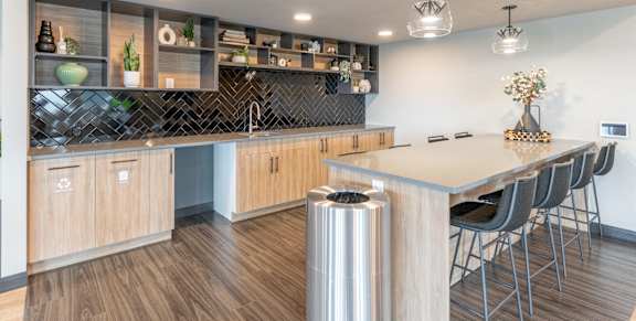 A modern kitchen with wooden cabinets and a large island.at Vista Apartments at Edgemont, Edmonton