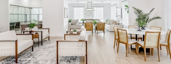 a living and dining room area with white walls and hardwood flooring