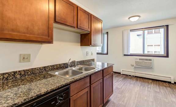 a kitchen with wood cabinets and granite countertops
