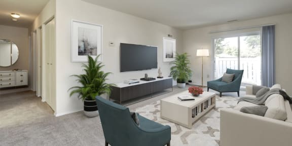 a living room with white couches and rattan chairs