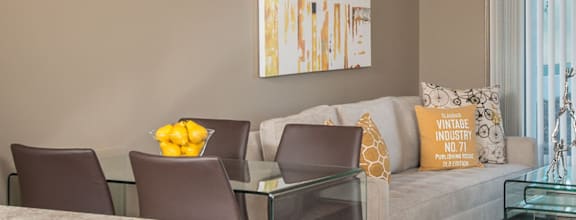 A modern dining room with a wooden table and chairs.