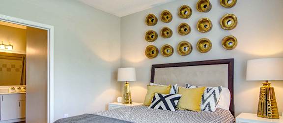 a bedroom with a bed and several plates on the wall