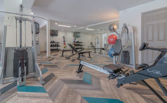 a gym with weights and cardio equipment in a home gym at City View Apartments at Warner Center, Woodland Hills, 91367