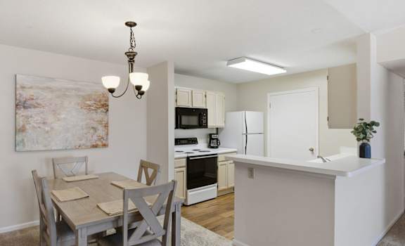A dining room with a table and chairs is shown.