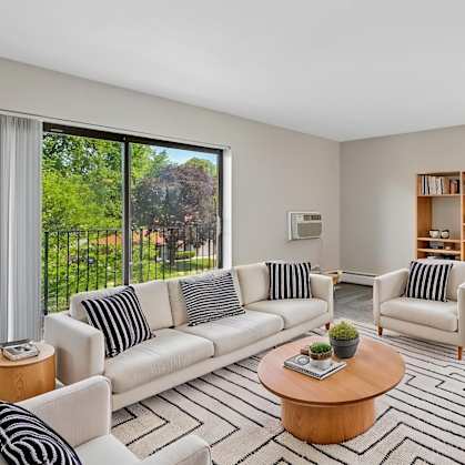 A living room with a white couch and a coffee table.