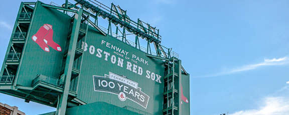 A green sign with the Red Sox logo and 100 years written on it.