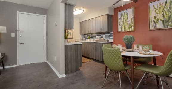 a dining room and kitchen with a table and chairs