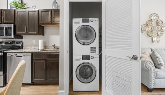 a living room and kitchen with a washing machine and a washer and dryer in it at Lofts at 335, Stratford, CT, 06615