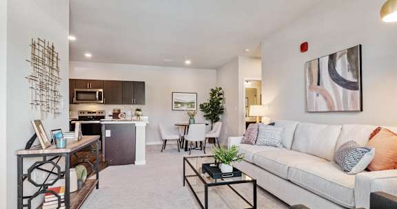 A modern living room with a white couch and a coffee table.