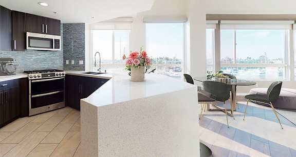 A modern kitchen with a large island and a view of the city. at Esprit Apartments, Marina del Rey, 90292