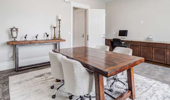 a conference room with a wooden table and chairs