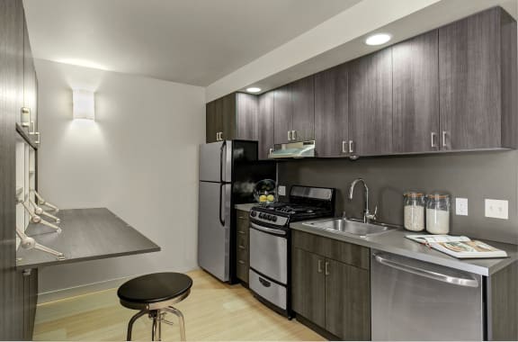 a kitchen with stainless steel appliances and a stainless steel counter top