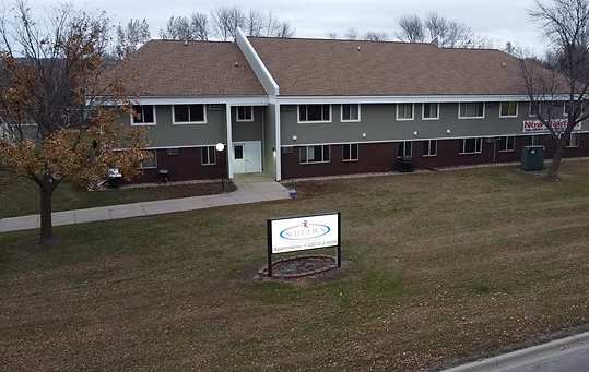 A building with a sign in front of it.