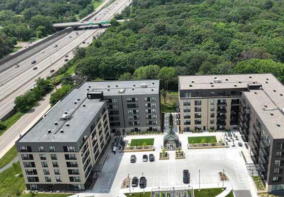 an aerial view of a group of buildings and a highway