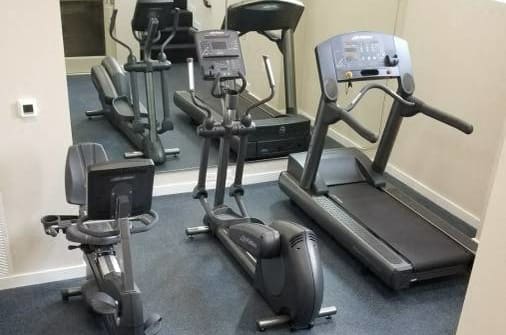 a room filled with lots of different types of exercise equipment