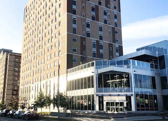 A tall building with a lot of windows is in the foreground.