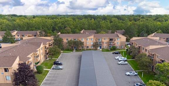 A parking lot in front of apartment buildings.