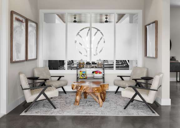 A modern living room with a large chandelier and a fireplace.