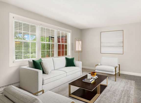 A living room with a couch, chair, and coffee table.