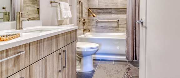 a bathroom with a toilet and a shower and a sink
