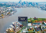 Thumbnail 1 of 40 - An aerial view of a city with a body of water and a sign that says Pacific Pointe Apartments.