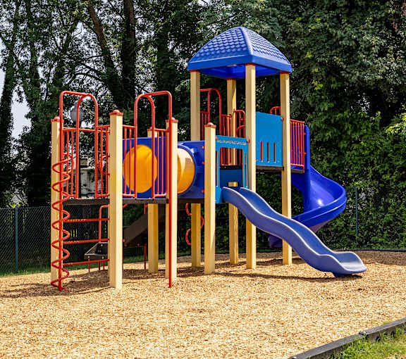 A playground with a blue slide at Seven Oaks Townhomes, Edgewood, 21040