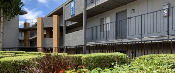 an apartment building with a balcony and a fence