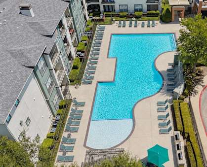 A large swimming pool surrounded by apartment buildings.