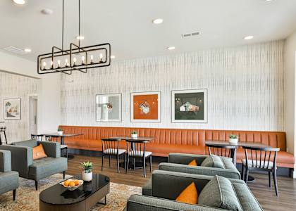 a living room with couches and chairs and a dining room with tables