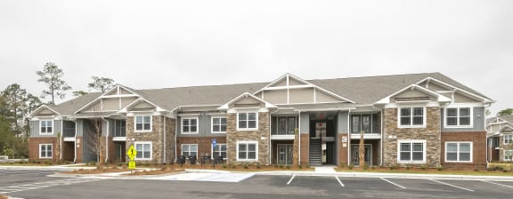an empty parking lot in front of an apartment building