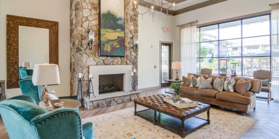 a living room with white couches and rattan chairs