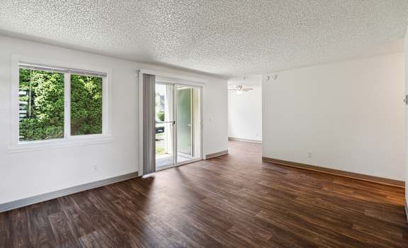 the living room and dining room of an apartment