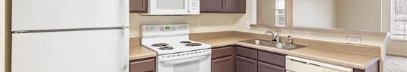 Modern kitchen with wood style flooring and countertops at Northampton Village Apartments, Indianapolis, IN