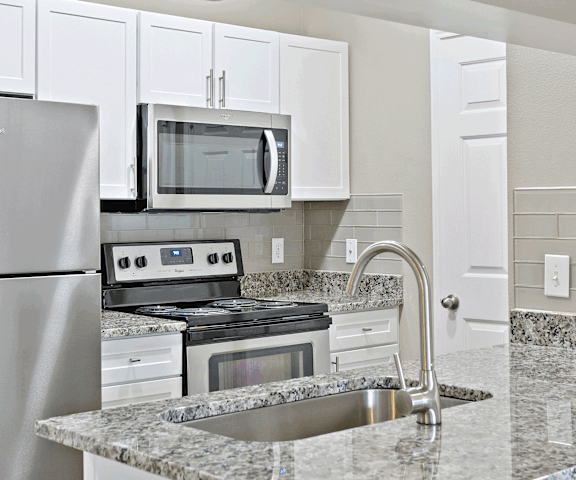 a kitchen with granite countertops and stainless steel appliances at Ventana Oaks Apartments, Austin, TX, 78717