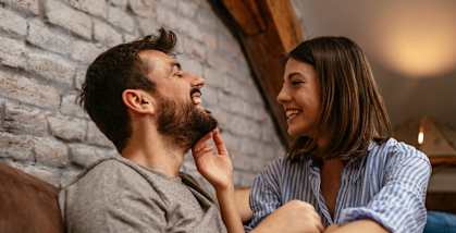 a man and a woman sitting on a couch laughingat First Street Lofts in Downtown Bismarck, Bismarck, 58506