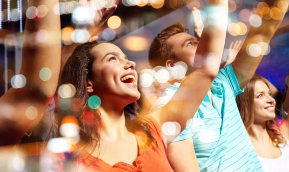 smiling friends at concert in club