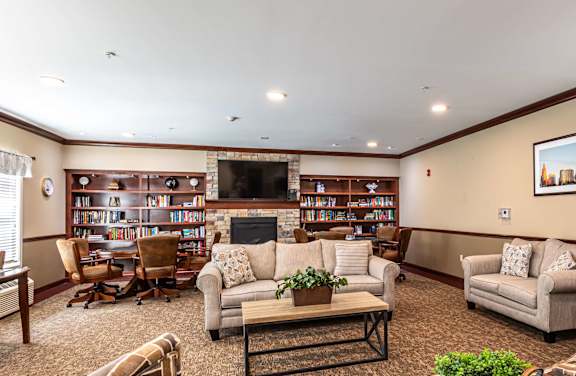 A living room with a fireplace and a bookshelf.